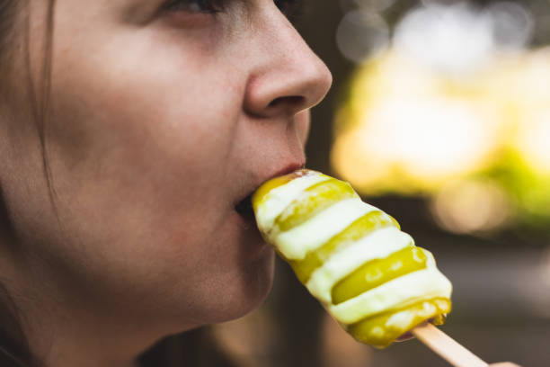 Close up of a young girl eating a spiral shaped green ice cream