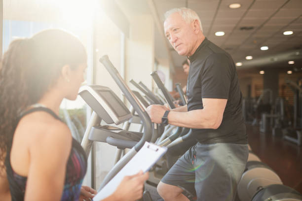 istock Fitness coach helping during training in a gym. 1164559921