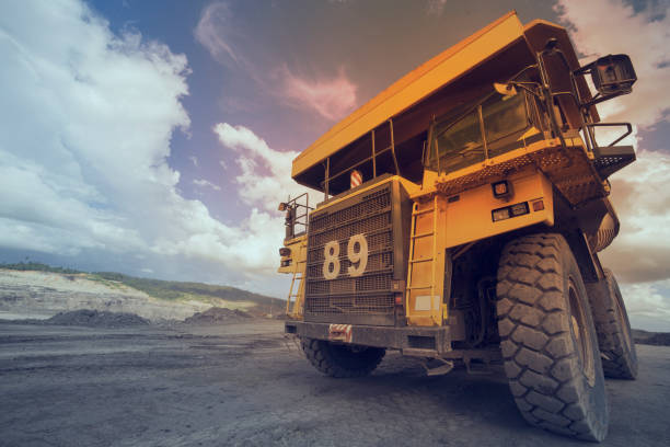 Big yellow mining truck on the dramatic sky and cloud stock photo