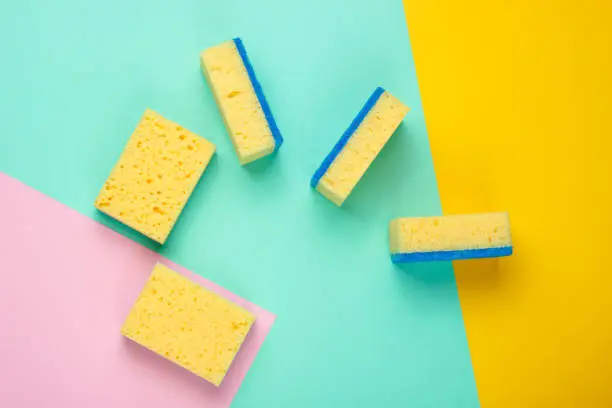 Cleaning minimalism concept. Sponges on a pastel background. Top view