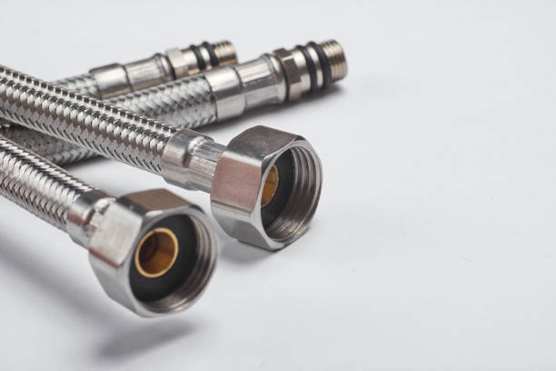 istock Two metal plumbing hoses on a white background 1164560687