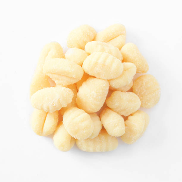 haufen frischer italienischer gnocchi, ansicht von oben über weiß - kartoffelknödel essen stock-fotos und bilder