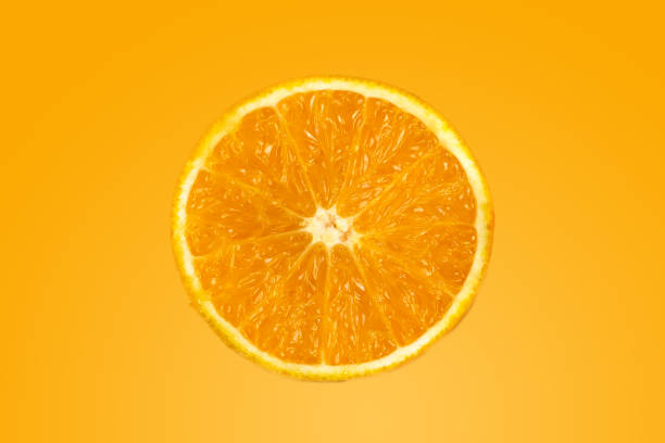 istock Background of half cut oranges on orange background 1164560962