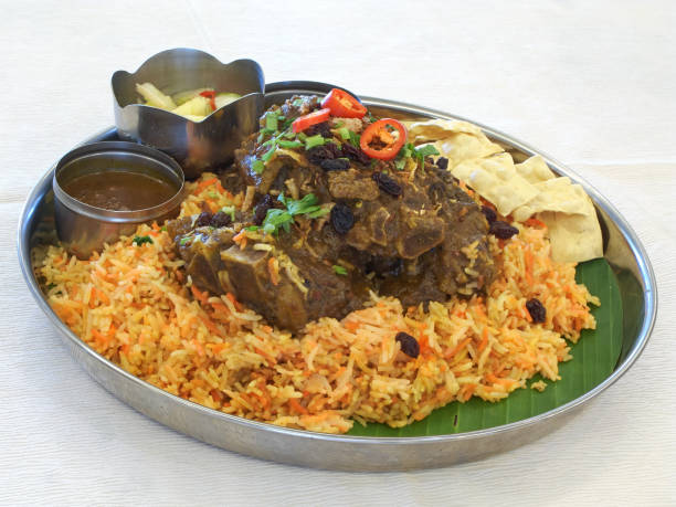 Indian style lamb biryani Indian style lamb biryani, with lamb, rice, peppers, herbs, pickled vegetables, and housemade sauce. Biryani stock pictures, royalty-free photos & images
