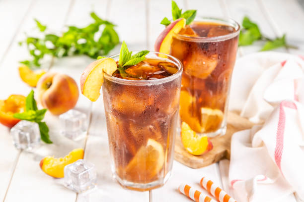 Ice tea and ingredients in glasses on wood background stock photo