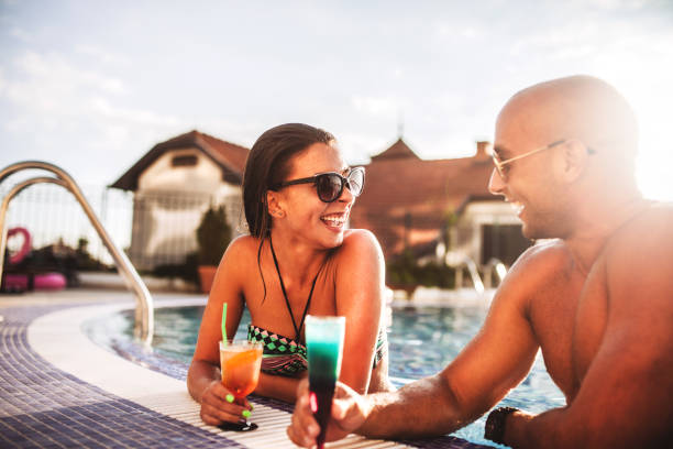 istock Happy couple  in luxury hotel pool 1164562087