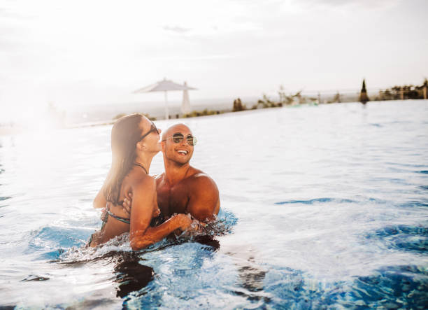 istock Happy couple  in luxury hotel pool 1164562690