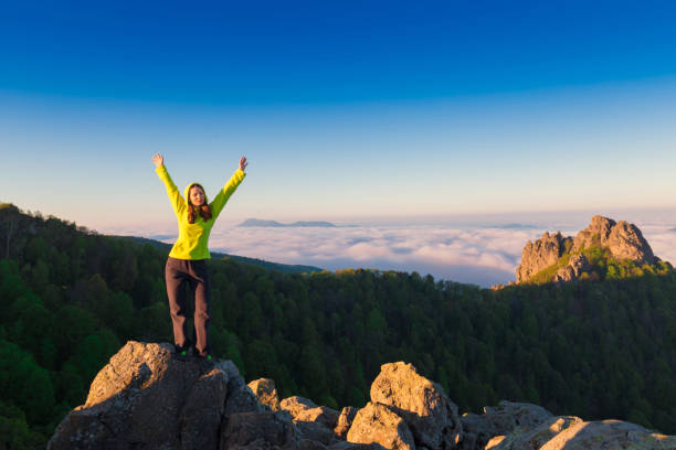 istock A woman on top mountain, summer cloudscape 1164562753