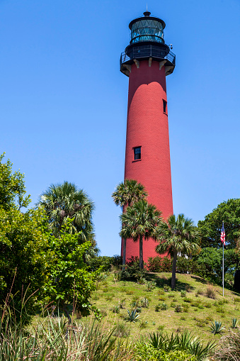 Jupiter Inlet Lighthouse sits atop a hill overlooking the Atlantic Ocean and Jupiter Inlet in Florida
