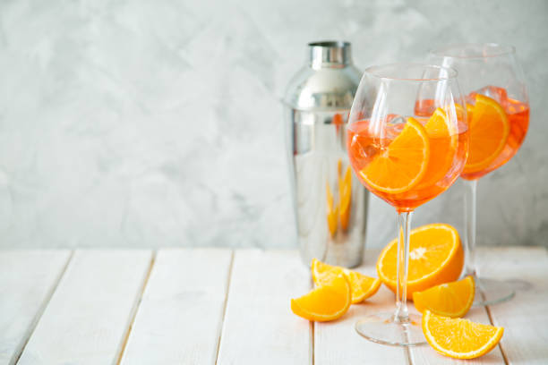 istock Aperol and ingredients drinks on wood background 1164562857