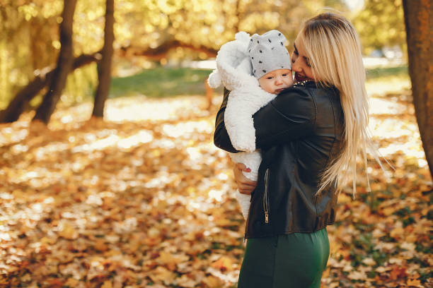istock Mother with daughter playing in a summer park 1164563070