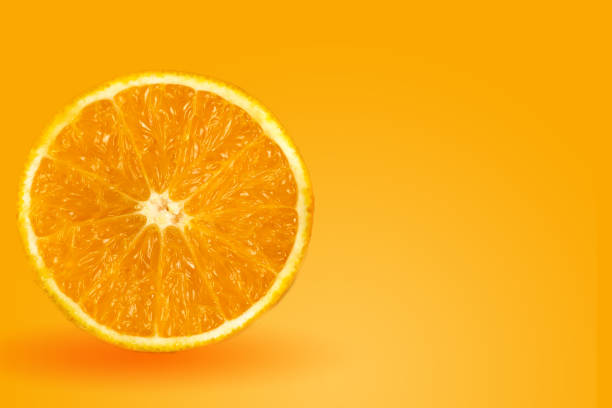 istock Background of half cut oranges on orange background 1164563161