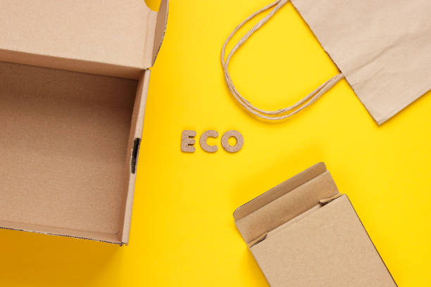 istock Eco concept. Cardboard boxes, paper bag on yellow background. Top view 1164563269