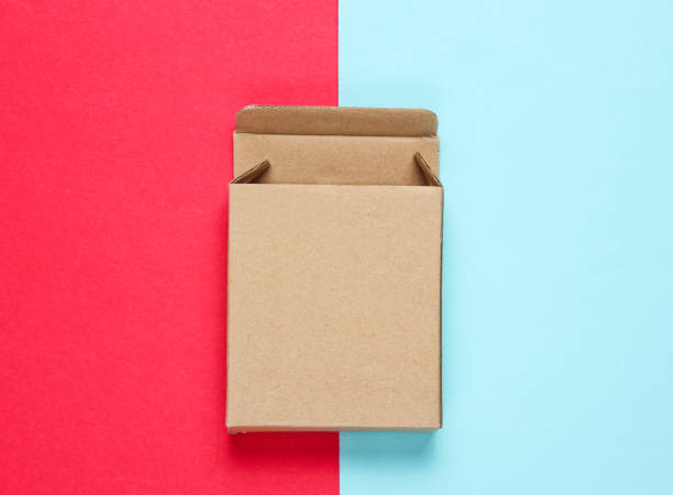 istock Empty cardboard box on color paper background. Top view 1164563293