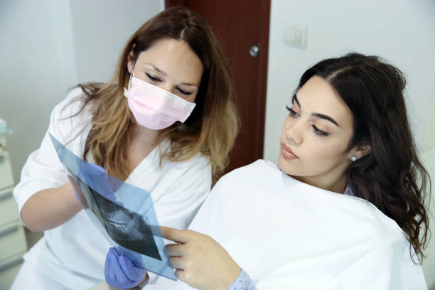 istock Dentist is Analyzing X-Ray Image at Dental Clinic 1164565031
