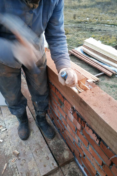 istock Man in gloves, work with a hammer and a bit of wood processing 1164566848