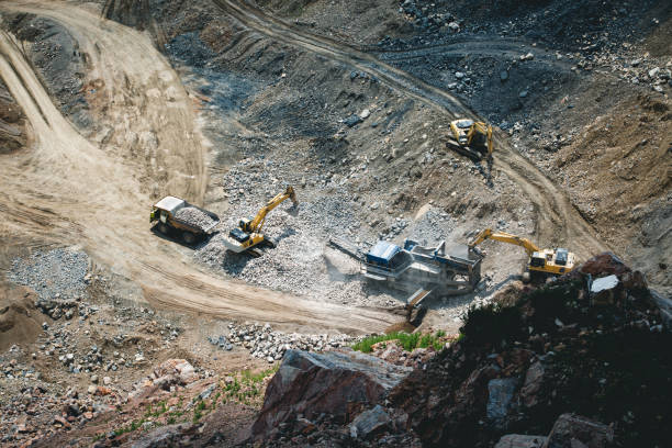 istock Excavator loading dumper truck on mining site stock photo 1164568342