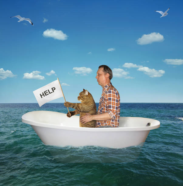 istock Man with his cat drift on the sea 2 1164568414