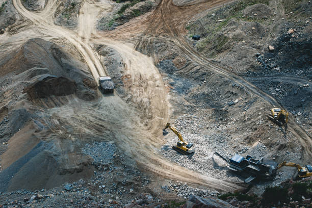 istock Excavator loading dumper truck on mining site stock photo 1164568437