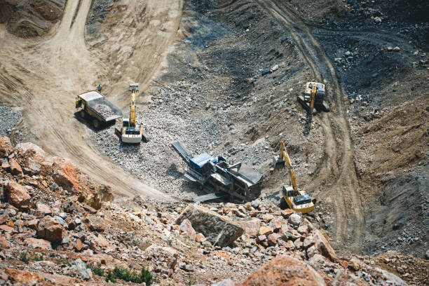 istock Excavator loading dumper truck on mining site stock photo 1164569069