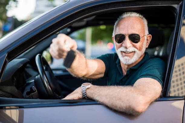 istock Happy senior man just bought his new car. 1164570456