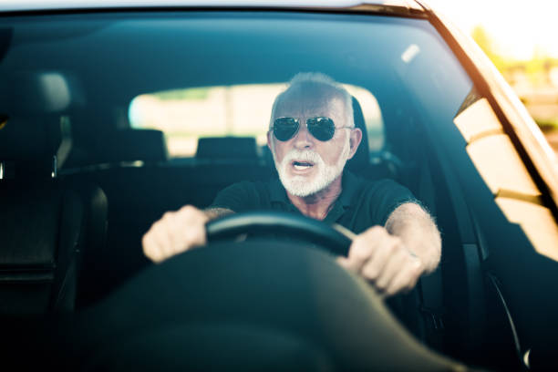 istock Angry senior man driving a car avoiding a car accident. 1164570799