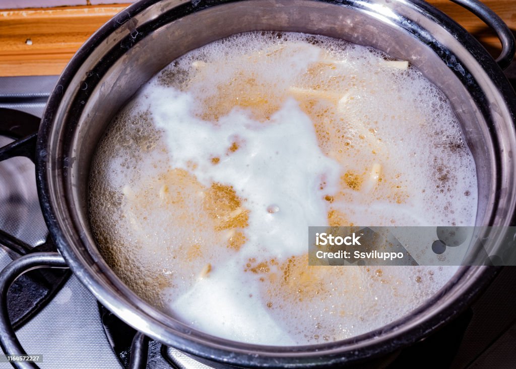 Pot with pasta boiling Pot with pasta boiling over the fire Pasta Stock Photo