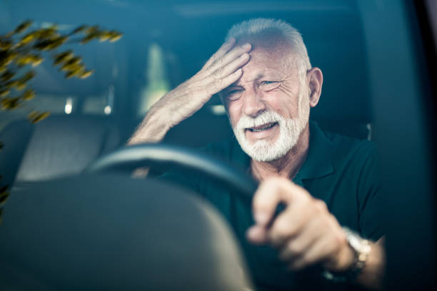 istock Senior man having a strong headache while driving a car. 1164572244