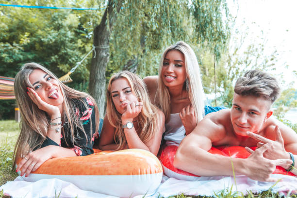 istock portrait millennial group of friends lying 1164578314