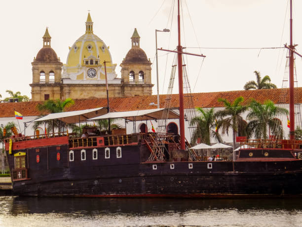 istock Colonial ship with colonial building and catholic temple in background 1164580175