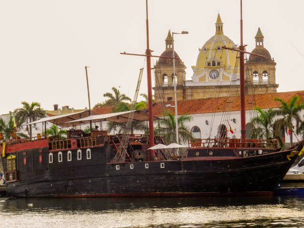 istock Colonial ship with colonial building and catholic temple in background 1164580182