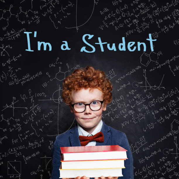 istock Little boy student on blackboard background with science formulas. Back to school concept 1164582272