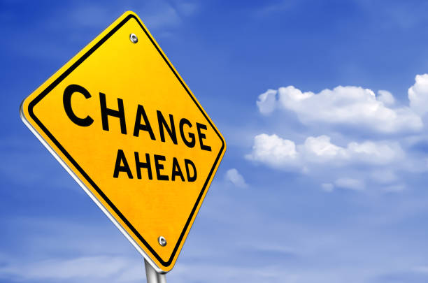 istock CHANGE AHEAD - yellow road sign information 1164582347