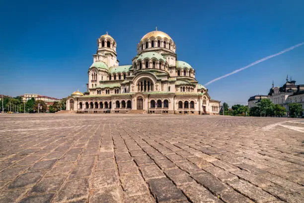 Wide angle panoramic photograph of Alexander Nevsky Cathedral, downtown district in city of Sofia, capital of Bulgaria, Eastern Europe. Photographed outdoors on a sunny day with clear blue sky. Shot on Canon EOS R full frame system RF premium lens for best quality.