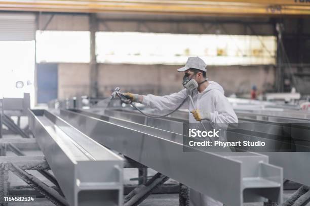 Man Painting Metal In Factory Stock Photo - Download Image Now - Painting - Activity, Industry, Paint