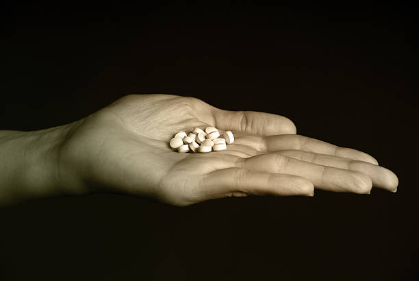istock Daily Pill Regimen - Pills in Female Hand 116458325