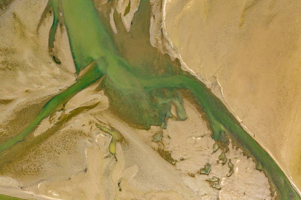 istock Drone image dircetly above of dried river bed due to climate change - creative stock image 1164585119