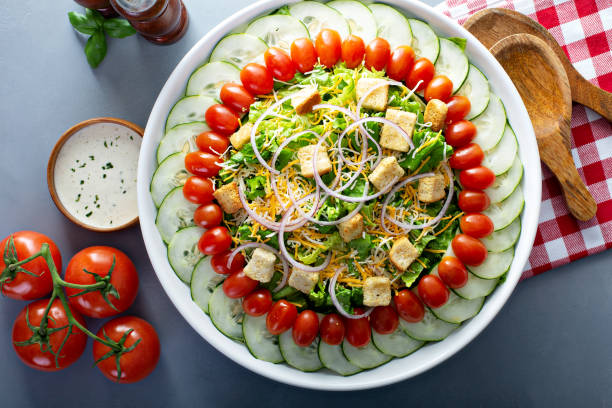 istock House salad with lettuce, cucumbers and tomatoes 1164585477