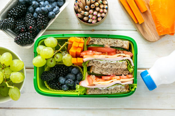 istock Back to school concept - lunch box with juice, apple and banana 1164586081
