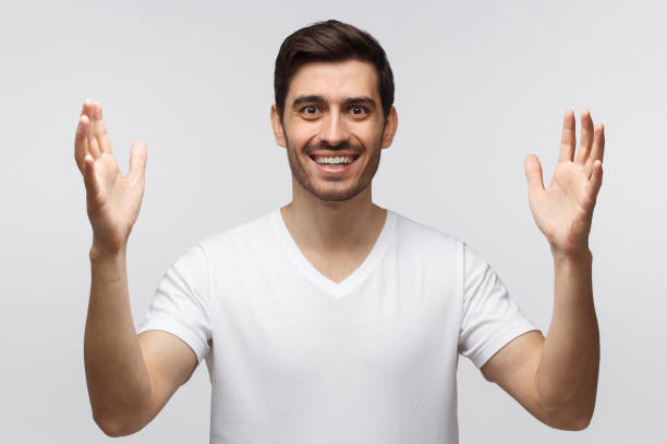 istock Young handsome man showing big size gesture with hands, emphasizing great amount of something 1164586451