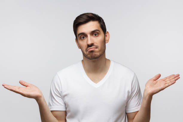 istock Young man showing helpless gesture with arm and hands, mouth curved as if he does not know what to do. I don't know. 1164586461