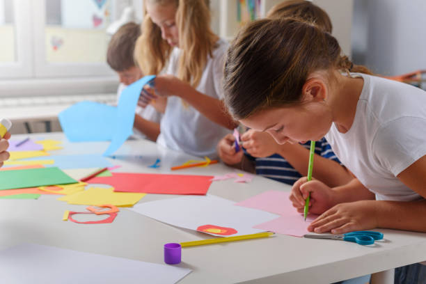 istock Creative kids making some paper arts and crafts 1164587417