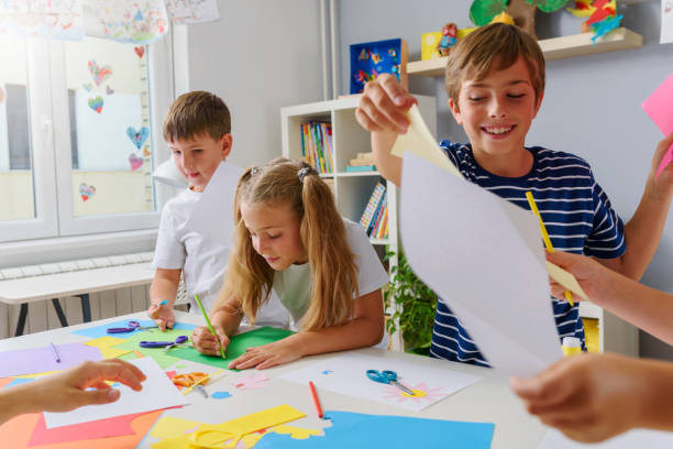 istock Creative kids making some paper arts and crafts 1164587547