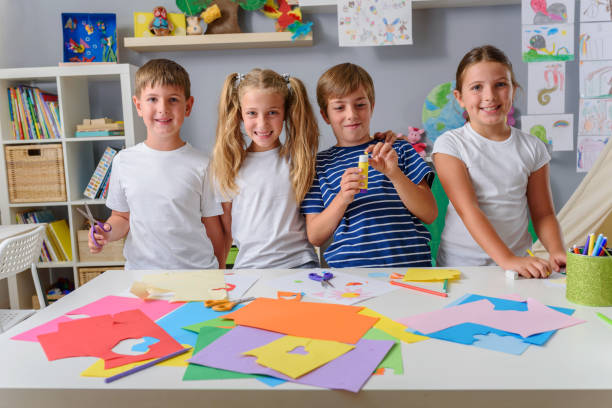 istock Creative kids making some paper arts and crafts 1164588104