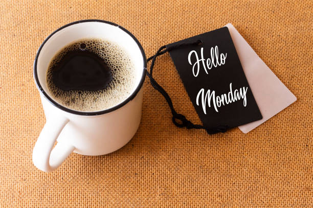 istock text HELLO MONDAY on tag with cup of aromatic coffee 1164591745