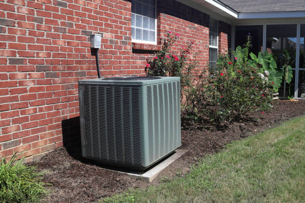 Home HVAC Unit next to modern brick home. Air Conditioner system next to a home, modern clean with bushes and brick wall compressor photos stock pictures, royalty-free photos & images