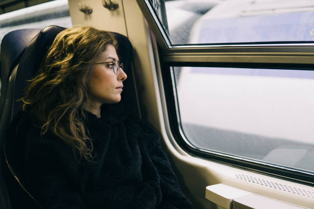 istock Young sad woman on a train 1164592734