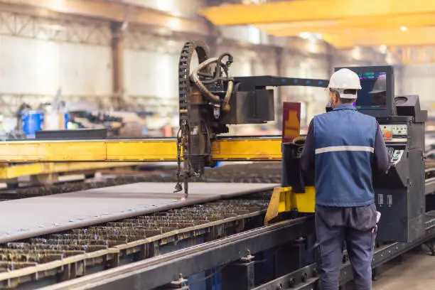 Photo of Steel worker on CNC plasma cutter machine