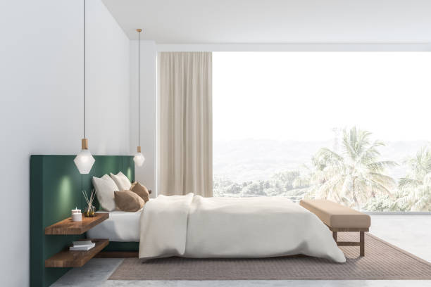 istock Side view of white and green bedroom 1164595984
