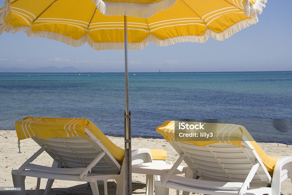 lounge chairs and parasol on the beach of saint-tropez summer on the french riviera Armchair Stock Photo